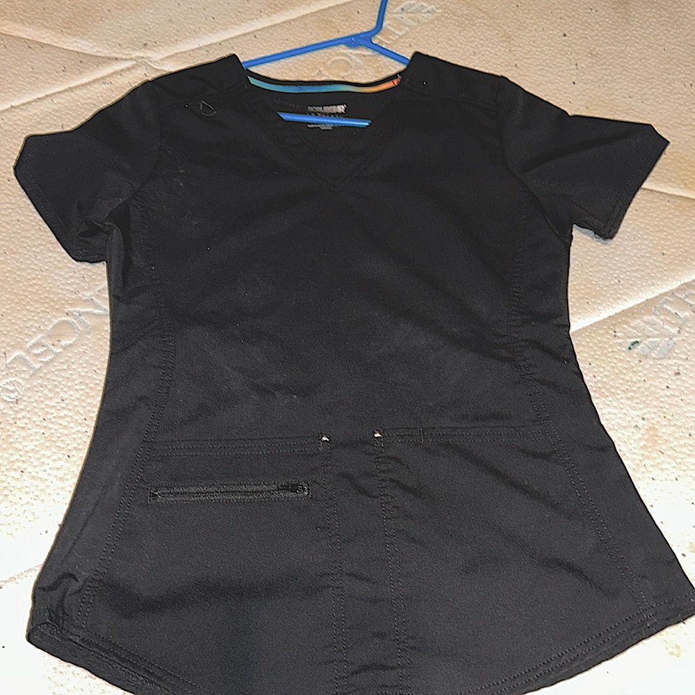 Two black scrub shirts with pockets and zippers